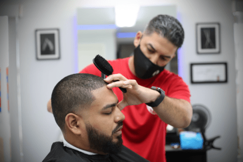 Man Cutting a person's hair - Barber and Web Developer